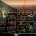 A drinks menu written on a glass sheet at The Abbeydale Picture House Bar. 