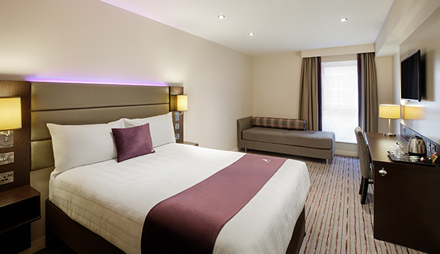 Premier Inn – double bedroom with bed, desk, and signature purple accents.