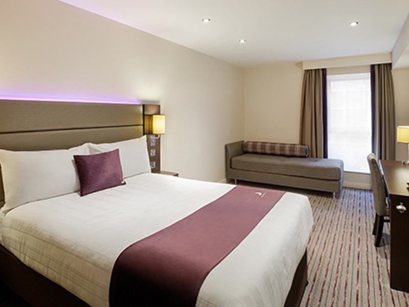 Premier Inn – double bedroom with bed, desk, and signature purple accents.