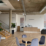 Inside Cubo, an open plan workspace with tables and chairs.