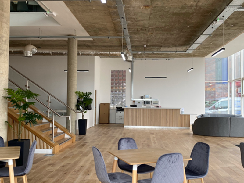 Inside Cubo, an open plan workspace with tables and chairs.