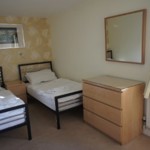 A twin room featuring two single beds and simple, cozy decor.