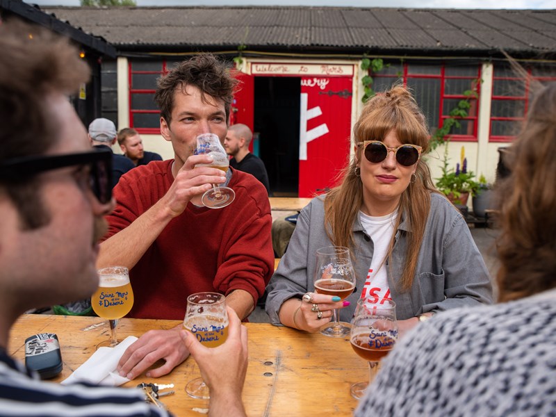 People drinking outdoors at The Brewery of St Mars of the Desert.