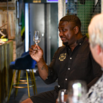 A man enjoying a glass of rum.