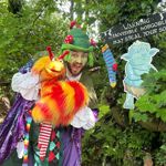 A person in a costume holding a bright puppet at the Tropical Butterfly House Wildlife Conservation Park.