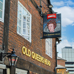 The exterior of The Old Queens Head with their pub sign.
