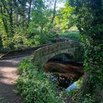 A stone bridge across a river on the Rivelin Valley Trail.