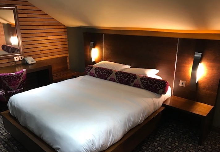 Double bedroom with a large bed, bedside tables, and cozy lighting.