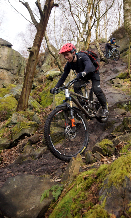 People mountain biking in the countryside.