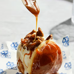 Toffee sauce being dribbled onto a dessert.