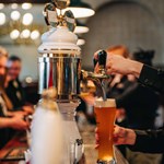 A bartender's hand pulling a pint at Sheffield Tap.