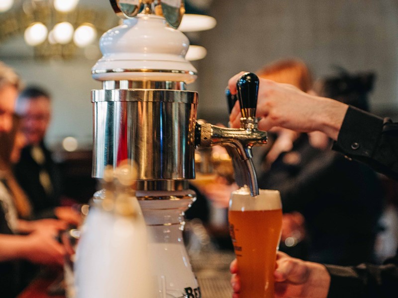 A bartender's hand pulling a pint at Sheffield Tap.