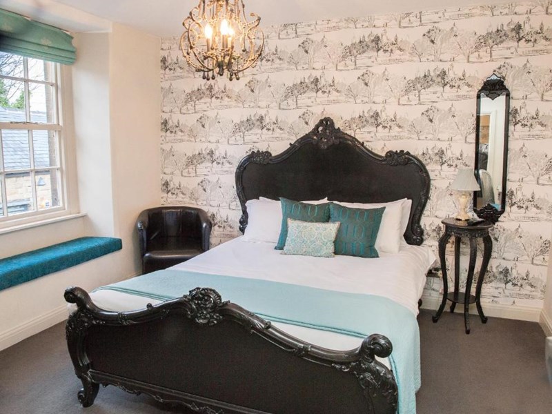 Spacious double bedroom with a large bed, ample floor space, bedside tables
