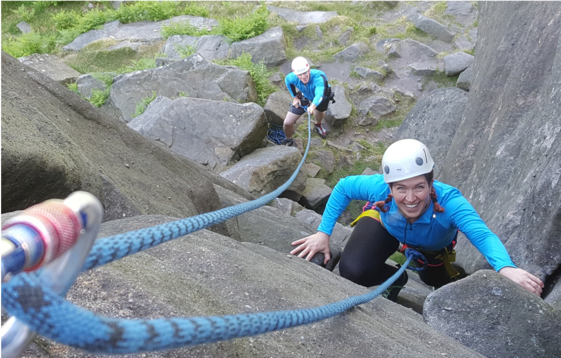 A person learning to rock climb.