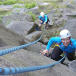 A person learning to rock climb.