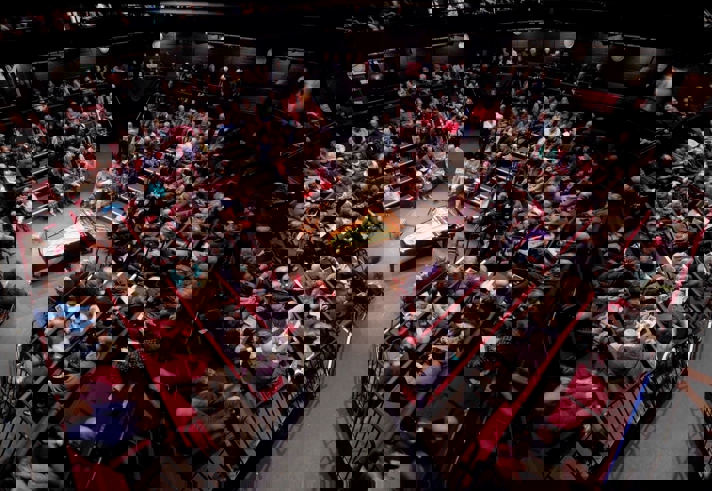 A packed house at the Crucible Theatre waits in anticipation for a classical concert to start. In the centre of the stage stands a grand piano.