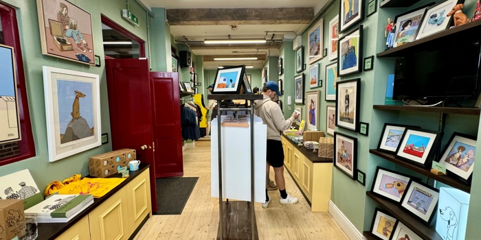 The interior of McKee Gallery, with the walls lines with prints for sale.