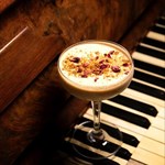 A cocktail on a piano keyboard.