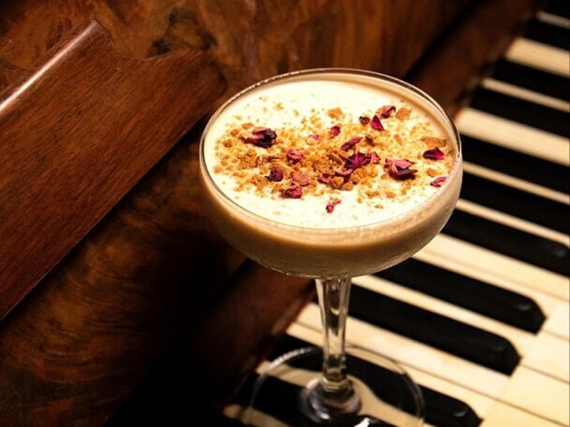 A cocktail on a piano keyboard.