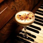 A cocktail on a piano keyboard.