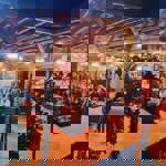 Groups of people sat at tables at Decks in the evening.