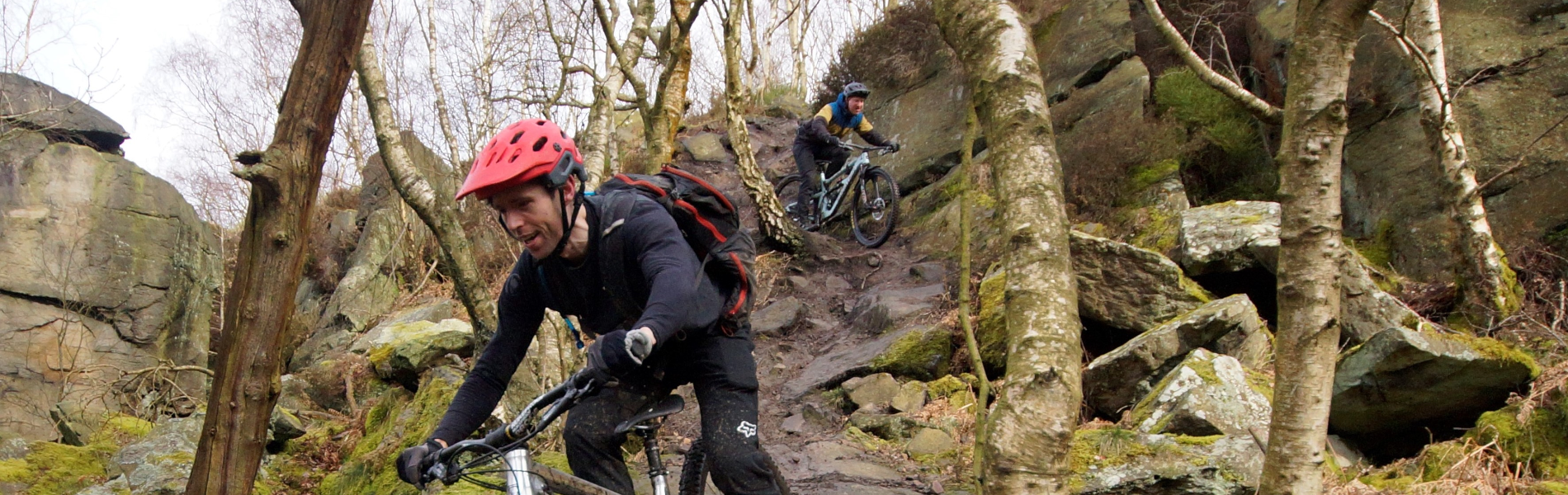 People mountain biking in the countryside.