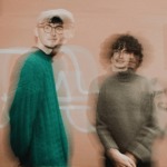 A blurred and out of focus picture of two people. 