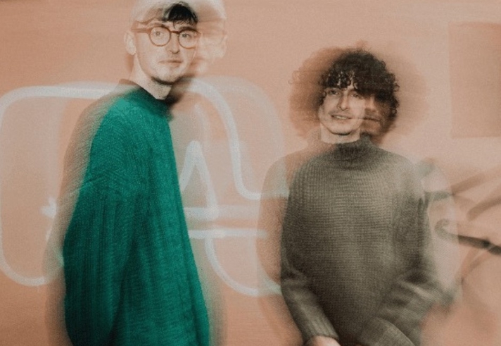 A blurred and out of focus picture of two people. 