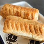 Two sausage rolls on a plate.