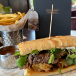 A steak sandwich with french fries at Miller & Carter Steakhouse.