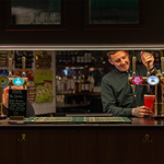 Two members of staff working behind the bar at Neepsend Social Club & Canteen