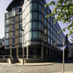 The corner exterior of the Mercure St Paul's Hotel on a sunny day