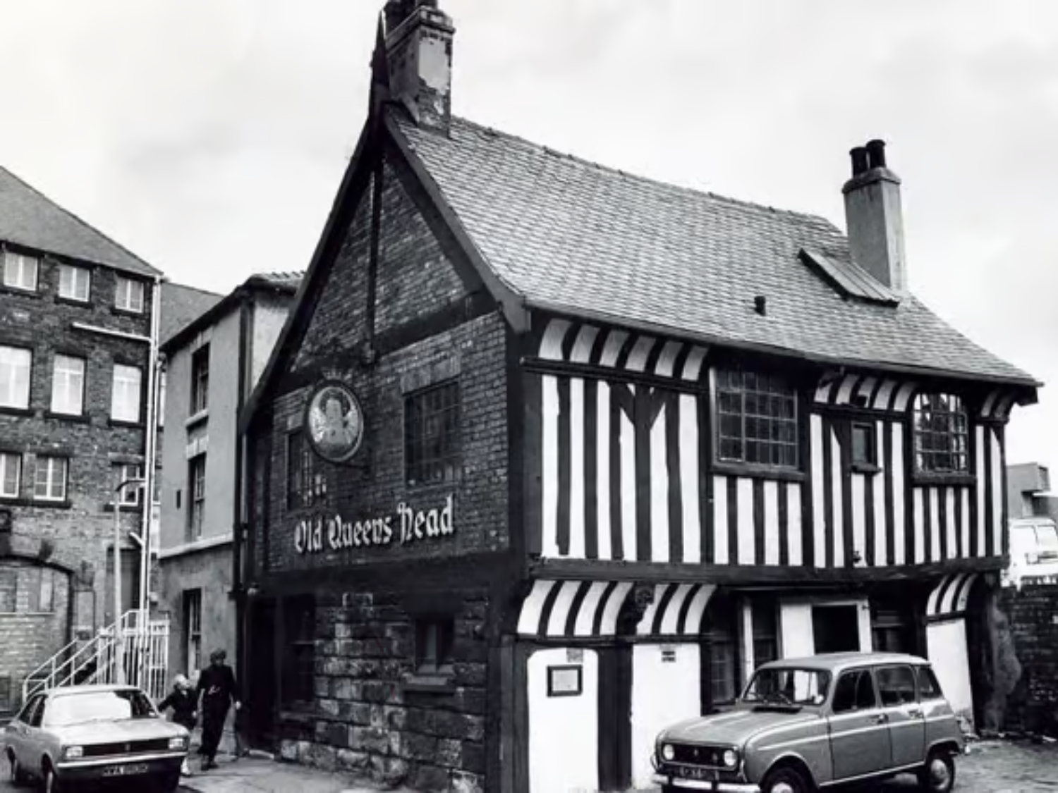 A black and white photo of the exterior of The Old Queens Head.