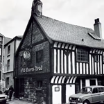 A black and white photo of the exterior of The Old Queens Head.