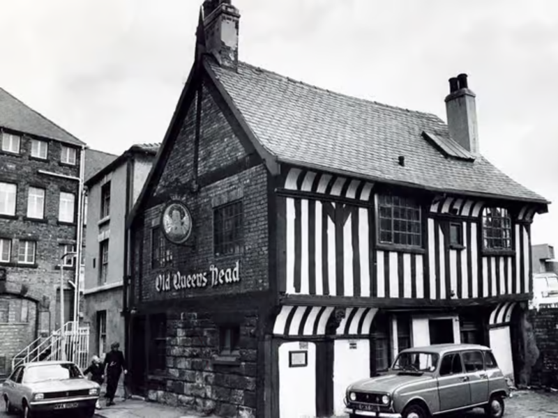 A black and white photo of the exterior of The Old Queens Head.