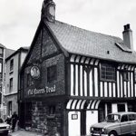 A black and white photo of the exterior of The Old Queens Head.