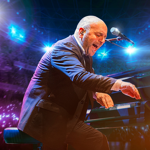 A performer in a dark suit is seated at a grand piano on a brightly lit stage. The musician is leaning forward with one arm extended toward the keys, while a microphone is positioned above the piano. The background shows vivid blue and purple stage lights and a large audience area illuminated with glowing lights.