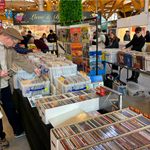 People browsing through crates of records at a record fair that has been set up in The Moor Market in Sheffield.