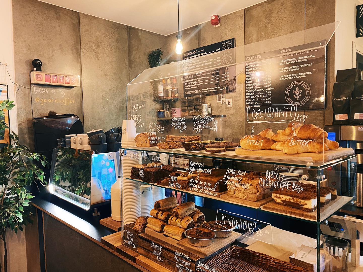 The counter at Gaard Coffee Hide, including a large glass case filled with baked goods.