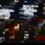 A white neon sign that reads 'Courtyard' on the wall at Monk Bar.