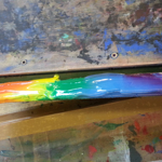 A rainbow of ink on a screen printing squeegee. 