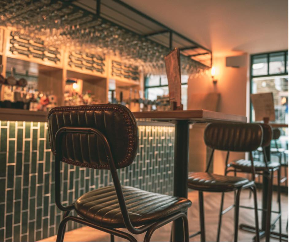 A high table with bar stools at The Dark Horse.