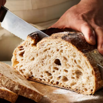 Bread being sliced at Dō Deli.