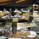 Elegantly set tables in the restaurant at Mercure St Paul's, featuring glassware and cutlery.