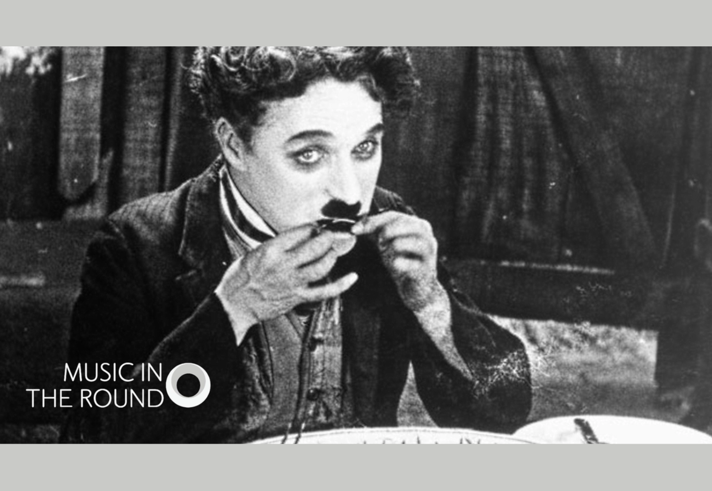 A still from The Gold Rush with Charlie Chaplin eating his shoelace. 
