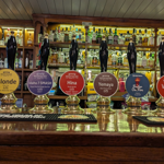 The bar at The Wellington, with a row of traditional beer pumps.