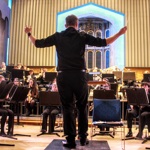 An orchestra performing on a stage.