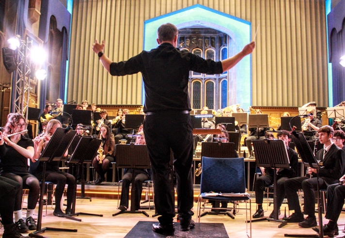 An orchestra performing on a stage.