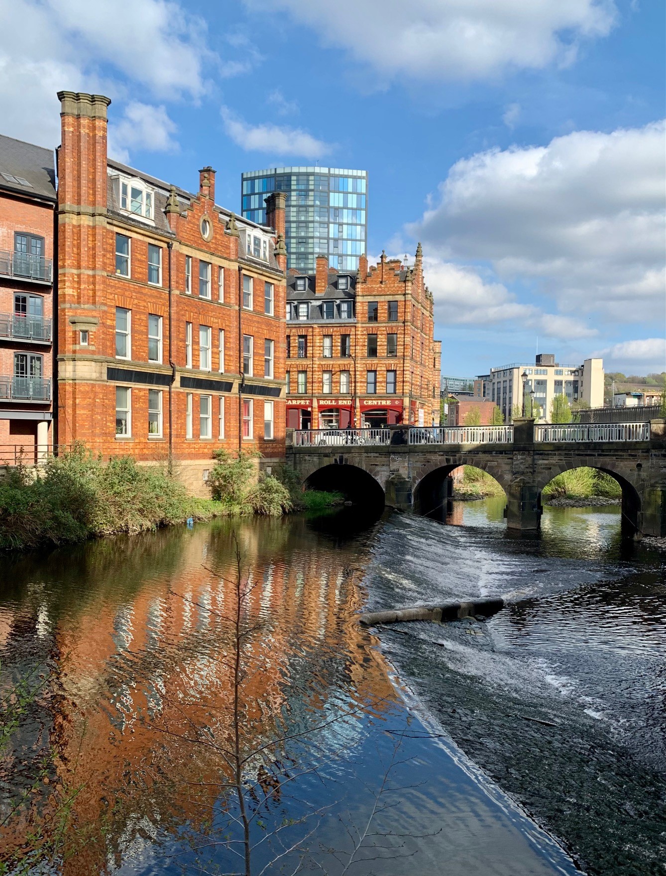 A weir on the River Don in the centre of Sheffield. In the background is Lady's Bridge.