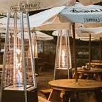 The beer garden at The Horse & Jockey with tables, umbrellas and heaters.